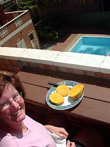 Megan eating mangoes on the balcony